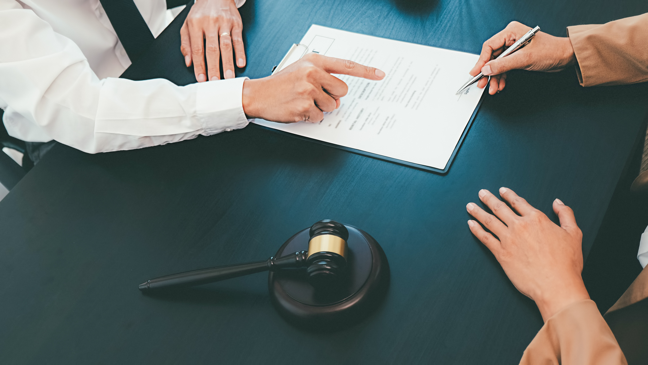 Client Signing a Document from Lawyer 